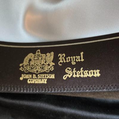 Bronzine felt Stetson Sutley fedora hat with a black grosgrain ribbon and feather accent. Size 7 1/4