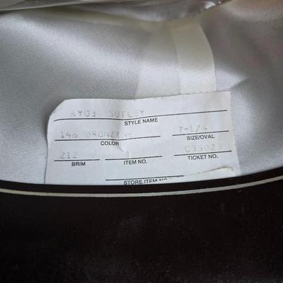 Bronzine felt Stetson Sutley fedora hat with a black grosgrain ribbon and feather accent. Size 7 1/4