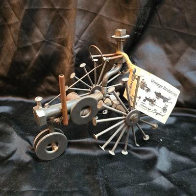 Days Of Splendor” John Deere framed artwork and a brutalist metal nail sculpture depicting a farmer on a tractor, created by artist...