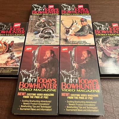 Sale Photo Thumbnail #104: Set of six Today’s Bowhunter Video Magazine tapes produced by PSE (Precision Shooting Equipment). Includes multiple 1994 issues covering topics such as caribou hunts in Quebec, antelope decoying, tuning with arrow spine, compound bow techniques, and int