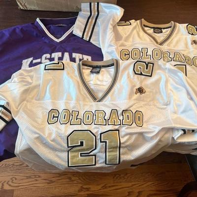 Sale Photo Thumbnail #115: Bundle of three college sports jerseys in good pre-owned condition:

Included:

Colorado Buffaloes Jersey – #21, Size L
White mesh with gold/black lettering and CU buffalo logo.

Colorado Buffaloes Jersey – #21, Size XL
Same style as above, larger siz
