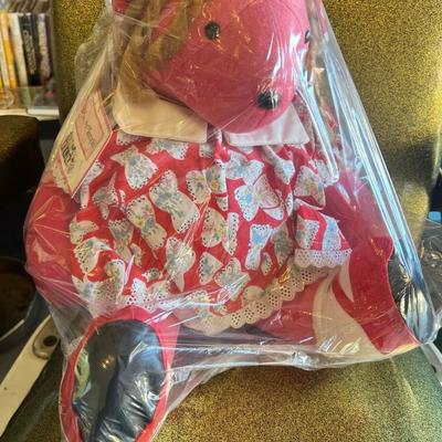 Sale Photo Thumbnail #121: Description:
Charming American Bear Company “Bearly Temple,” a parody of Shirley Temple. Bear features signature curls, vibrant dress, and lace trim. Original hang tag attached and preserved inside factory plastic. Excellent piece for character bear c