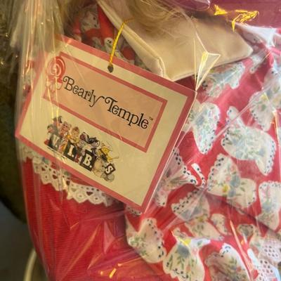 Sale Photo Thumbnail #120: Description:
Charming American Bear Company “Bearly Temple,” a parody of Shirley Temple. Bear features signature curls, vibrant dress, and lace trim. Original hang tag attached and preserved inside factory plastic. Excellent piece for character bear c