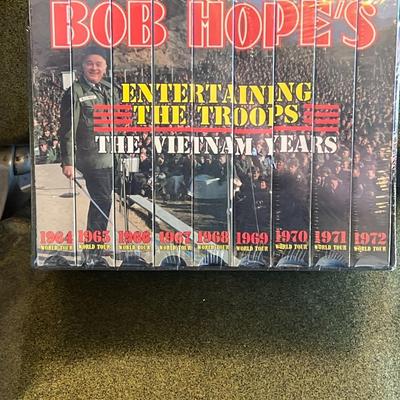 Sale Photo Thumbnail #130: Rare new-in-box, still factory-sealed Bob Hope’s Entertaining the Troops: The Vietnam Years VHS collection.
Includes all 8 volumes, each covering a different year of Bob Hope’s USO World Tour:

1964 World Tour

1965 World Tour

1966 World Tour

1967 W