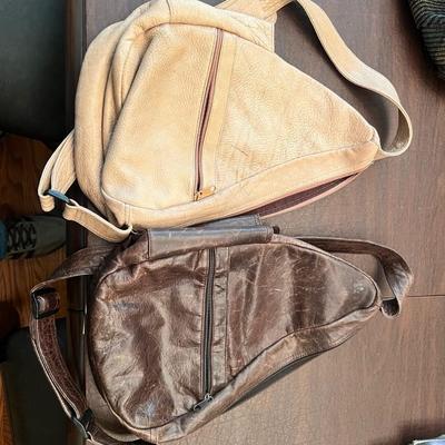 Sale Photo Thumbnail #133: Set of two authentic Lopez Camelio sling-style leather backpacks, handcrafted in Mexico. Both feature the signature ergonomic triangular design, adjustable shoulder strap, exterior zipper pocket, and full zip-around closure. Includes one rich brown leathe