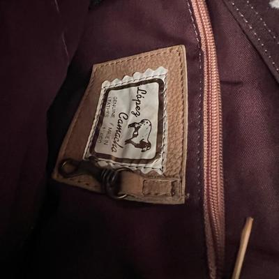 Sale Photo Thumbnail #132: Set of two authentic Lopez Camelio sling-style leather backpacks, handcrafted in Mexico. Both feature the signature ergonomic triangular design, adjustable shoulder strap, exterior zipper pocket, and full zip-around closure. Includes one rich brown leathe