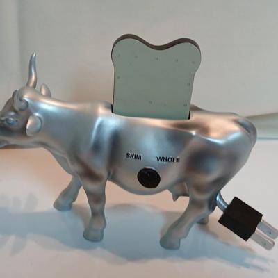 Cow parade Milk Toast with a calf peeking off the shelf