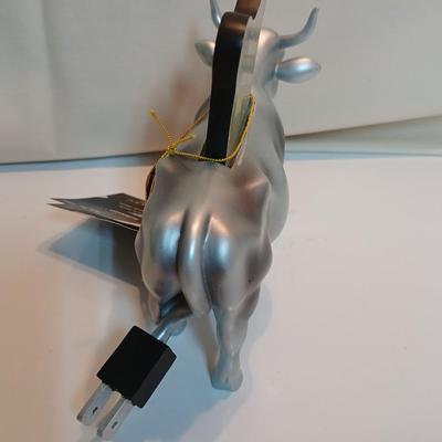 Cow parade Milk Toast with a calf peeking off the shelf