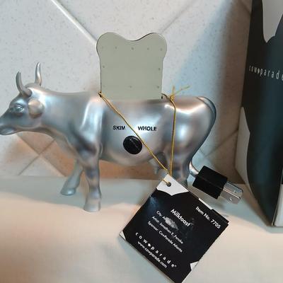 Cow parade Milk Toast with a calf peeking off the shelf