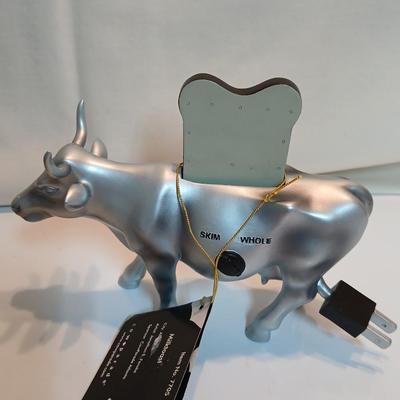 Cow parade Milk Toast with a calf peeking off the shelf