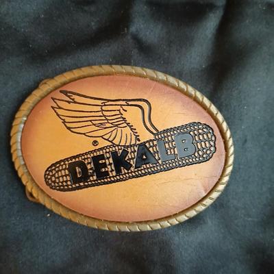 Advertisement buckles = Dekalb advertising belt buckle featuring the "flying corn cob" logo. & a Pioneer Seed Company oval...