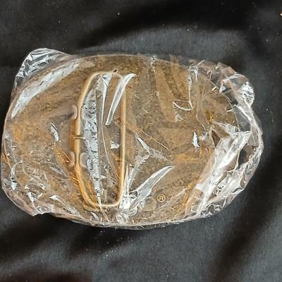 Advertisement buckles = Dekalb advertising belt buckle featuring the "flying corn cob" logo. & a Pioneer Seed Company oval...