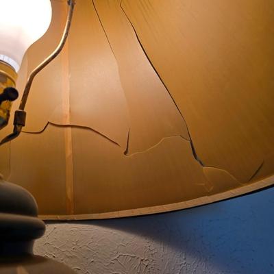 Small natural wood shelf with large ceramic lamp with an iris on it