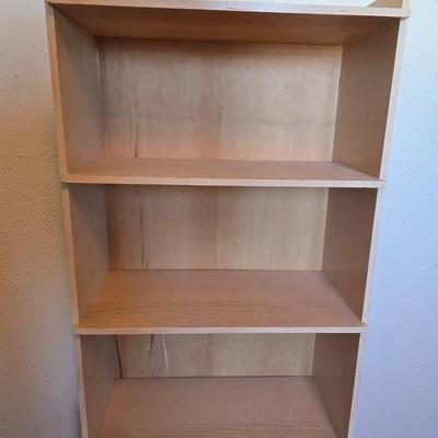 Small natural wood shelf with large ceramic lamp with an iris on it