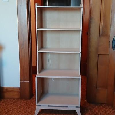 Small natural wood shelf with large ceramic lamp with an iris on it