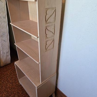 Small natural wood shelf with large ceramic lamp with an iris on it