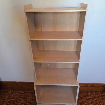 Small natural wood shelf with large ceramic lamp with an iris on it