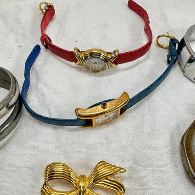 Sale Photo Thumbnail #169: All watches are from one collection, none of them are running assume all need new batteries or maybe other work. 1 Vintage non working pocket watch. Cuff watches, some stones and crystal. Watch bands.