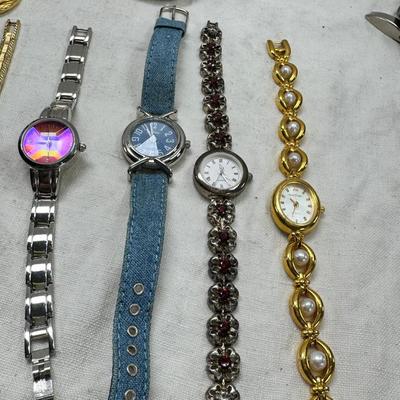 Sale Photo Thumbnail #167: All watches are from one collection, none of them are running assume all need new batteries or maybe other work. 1 Vintage non working pocket watch. Cuff watches, some stones and crystal. Watch bands.