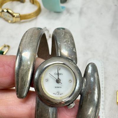 Sale Photo Thumbnail #176: All watches are from one collection, none of them are running assume all need new batteries or maybe other work. 1 Vintage non working pocket watch. Cuff watches, some stones and crystal. Watch bands.