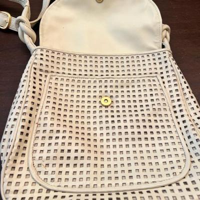Sale Photo Thumbnail #136: Stylish vintage cream leather shoulder/crossbody bag featuring an attractive perforated square-cut pattern on the front and body. Magnetic snap closures on both the main flap and front pocket. Adjustable strap with knotted design at each side. Interior is