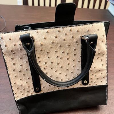 Sale Photo Thumbnail #139: Chic small handbag featuring a faux ostrich leather exterior in cream with contrasting black trim and handles. Interior is fully lined in a stylish leopard print fabric with multiple pockets for organization.
Magnetic snap closure stamped OKPTA 1519426 / 