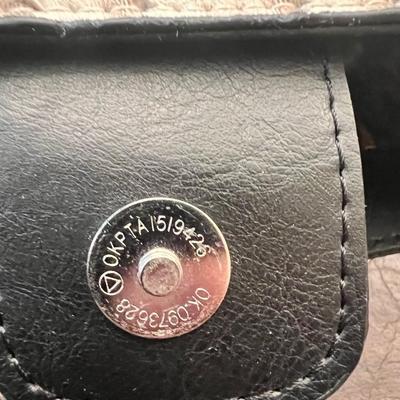 Sale Photo Thumbnail #137: Chic small handbag featuring a faux ostrich leather exterior in cream with contrasting black trim and handles. Interior is fully lined in a stylish leopard print fabric with multiple pockets for organization.
Magnetic snap closure stamped OKPTA 1519426 / 