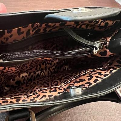 Sale Photo Thumbnail #138: Chic small handbag featuring a faux ostrich leather exterior in cream with contrasting black trim and handles. Interior is fully lined in a stylish leopard print fabric with multiple pockets for organization.
Magnetic snap closure stamped OKPTA 1519426 / 