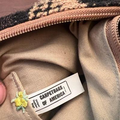 Sale Photo Thumbnail #145: Unique vintage Carpetbags of America shoulder bag featuring a bold black-and-tan woven wave pattern. This style is known for its durable tapestry construction and artisan-made quality.
The interior is lined with a natural canvas fabric and includes the or