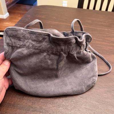 Sale Photo Thumbnail #149: Elegant vintage J. Renée by Renaic gray suede evening bag, featuring a soft gathered/pleated top and matching suede strap. The interior is lined in smooth gray satin with a zippered pocket and the original J. Renée label intact. Compact and stylish—pe