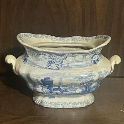 Sale Photo Thumbnail #197: Beautiful antique blue & white transferware ironstone jardinière featuring a scenic pastoral village landscape on all sides. The piece has ornate floral borders, raised side handles, and classic early English-style transfer design. The glaze shows unifor