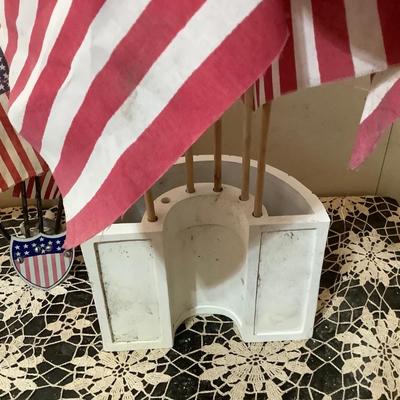 Sale Photo Thumbnail #4: Two flag holders one is wood newer holds 6 flags the other is metal vintage mounts on the wall holds 5 flags.