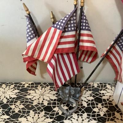 Sale Photo Thumbnail #2: Two flag holders one is wood newer holds 6 flags the other is metal vintage mounts on the wall holds 5 flags.