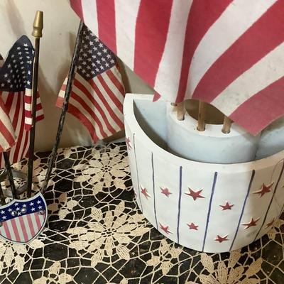 Sale Photo Thumbnail #5: Two flag holders one is wood newer holds 6 flags the other is metal vintage mounts on the wall holds 5 flags.