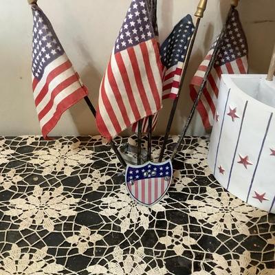 Sale Photo Thumbnail #3: Two flag holders one is wood newer holds 6 flags the other is metal vintage mounts on the wall holds 5 flags.
