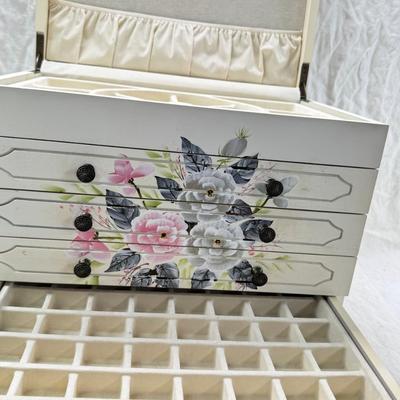Sale Photo Thumbnail #228: Thomas Pacomi designer, 15X11 with 4 drawers and a lift off lid. Very heavy , with hand painted floral design in good condition. The drawers are divided for all kinds of jewelry. There is one repair photoed, to the edge of one of the drawers.