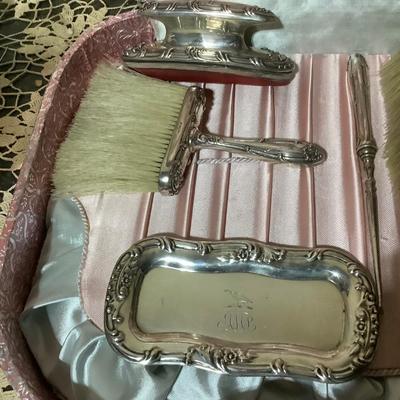 Sale Photo Thumbnail #240: You get a great silver plated dresser set. Brush, mirror, shoe brush, broom, tray, nail polisher.  The case is a light pink.  Very nice.