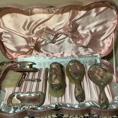 Sale Photo Thumbnail #238: You get a great silver plated dresser set. Brush, mirror, shoe brush, broom, tray, nail polisher.  The case is a light pink.  Very nice.
