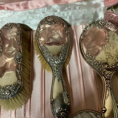 Sale Photo Thumbnail #239: You get a great silver plated dresser set. Brush, mirror, shoe brush, broom, tray, nail polisher.  The case is a light pink.  Very nice.