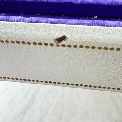 Sale Photo Thumbnail #240: Lined with purple material this "leatherette" box has divided drawers and is in good condition except for one small nick to one of the drawer fronts and a few areas of discoloration which I have not tried to clean. Measures 10X10X9"