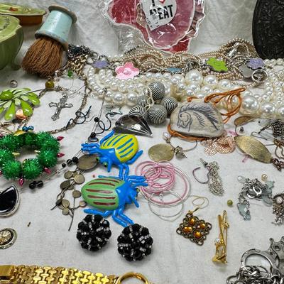 Sale Photo Thumbnail #300: Victorian vanity items, mirror, celluloid brush, shaving brush, early plastic containers. Beads, chains, Jewelry, necklaces, pins, bracelets, there are some strands that might need repair, there is a bag of extra beads, single earrings and of course a bag