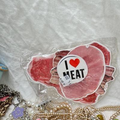 Sale Photo Thumbnail #299: Victorian vanity items, mirror, celluloid brush, shaving brush, early plastic containers. Beads, chains, Jewelry, necklaces, pins, bracelets, there are some strands that might need repair, there is a bag of extra beads, single earrings and of course a bag