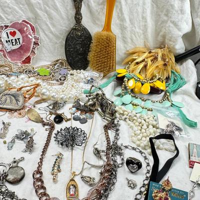 Sale Photo Thumbnail #297: Victorian vanity items, mirror, celluloid brush, shaving brush, early plastic containers. Beads, chains, Jewelry, necklaces, pins, bracelets, there are some strands that might need repair, there is a bag of extra beads, single earrings and of course a bag
