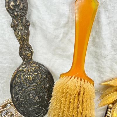 Sale Photo Thumbnail #298: Victorian vanity items, mirror, celluloid brush, shaving brush, early plastic containers. Beads, chains, Jewelry, necklaces, pins, bracelets, there are some strands that might need repair, there is a bag of extra beads, single earrings and of course a bag