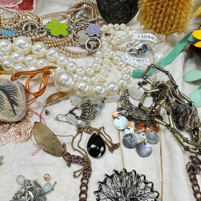 Sale Photo Thumbnail #308: Victorian vanity items, mirror, celluloid brush, shaving brush, early plastic containers. Beads, chains, Jewelry, necklaces, pins, bracelets, there are some strands that might need repair, there is a bag of extra beads, single earrings and of course a bag