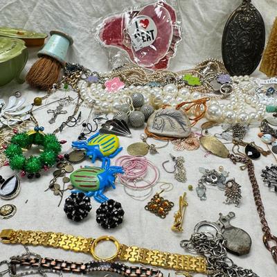 Sale Photo Thumbnail #314: Victorian vanity items, mirror, celluloid brush, shaving brush, early plastic containers. Beads, chains, Jewelry, necklaces, pins, bracelets, there are some strands that might need repair, there is a bag of extra beads, single earrings and of course a bag