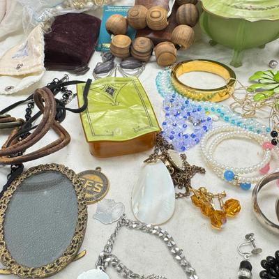Sale Photo Thumbnail #303: Victorian vanity items, mirror, celluloid brush, shaving brush, early plastic containers. Beads, chains, Jewelry, necklaces, pins, bracelets, there are some strands that might need repair, there is a bag of extra beads, single earrings and of course a bag