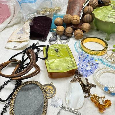 Sale Photo Thumbnail #302: Victorian vanity items, mirror, celluloid brush, shaving brush, early plastic containers. Beads, chains, Jewelry, necklaces, pins, bracelets, there are some strands that might need repair, there is a bag of extra beads, single earrings and of course a bag