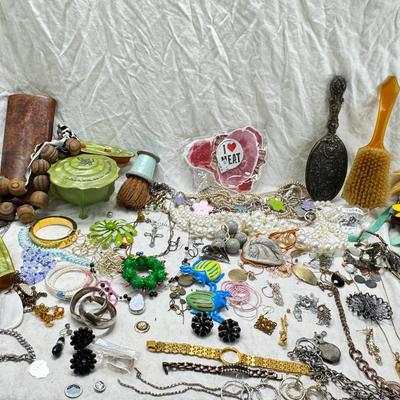 Sale Photo Thumbnail #296: Victorian vanity items, mirror, celluloid brush, shaving brush, early plastic containers. Beads, chains, Jewelry, necklaces, pins, bracelets, there are some strands that might need repair, there is a bag of extra beads, single earrings and of course a bag