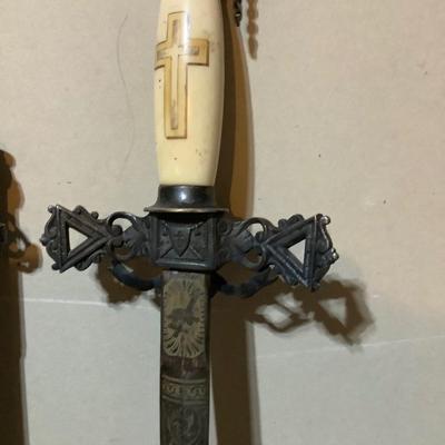 Sale Photo Thumbnail #222: This is a great religious sword with etched s blade and cross.